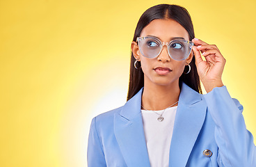 Image showing Thinking, woman and face with sunglasses in studio, yellow background and mockup space with confident model with style. Stylish, frames and gen z person with an idea with cool fashion or glasses