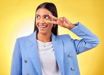 Image showing Peace sign, happy and woman with a smile and business fashion with emoji hand sign in studio. Yellow background, female person and v gesture with freedom, trendy style and worker with confidence