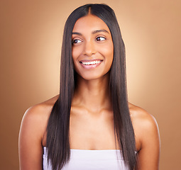 Image showing Texture, hair and skincare with face of woman in studio for keratin, salon treatment and beauty. Shampoo, health and growth with Indian model on brown background for glamour, shine and hairstyle