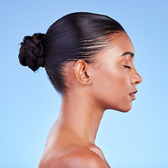 Image showing Woman, skincare and profile of natural beauty or shine on skin from cosmetics on blue background in studio with calm model. Dermatology, facial and healthy glow from makeup, wellness or self care