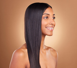 Image showing Smile, hair and skincare with face of woman in studio for keratin, salon treatment and texture. Shampoo, health and vision with Indian model on brown background for glamour, shine and hairstyle