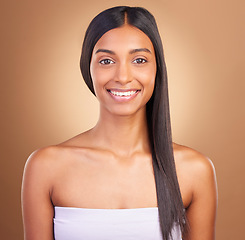 Image showing Portrait, hair care and woman with beauty, dermatology and skincare on a brown studio background. Face, person and model with shine, aesthetic or glow with healthy skin, wellness or volume with smile