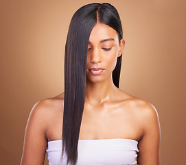 Image showing Beauty, hair and keratin with face of woman in studio for cosmetics, salon treatment and texture. Shampoo, health and growth with Indian model on brown background for glamour, shine and hairstyle