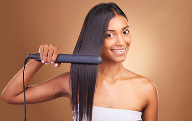 Image showing Straightener, hair care and woman portrait with smile and happy from Brazilian treatment in studio. Salon, natural beauty and hairdresser tool for healthy hairstyle and wellness with brown background
