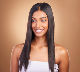 Image showing Beauty, hair care and smile with face of woman in studio for keratin, salon treatment and texture. Shampoo, health and growth with indian model on brown background for glamour, shine and hairstyle