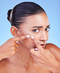 Image showing Acne, problem and portrait of woman with pimple in studio for cosmetic, mistake or disaster on blue background. Beauty, fail and face of female model with sensitive skin and diy blackhead removal