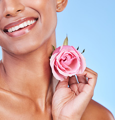 Image showing Woman with rose, closeup and natural beauty with sustainable skincare isolated on blue background. Wellness, skin glow and eco friendly cosmetics with pink flower, product and nature in a studio