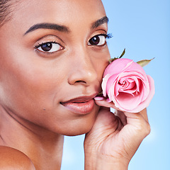 Image showing Rose, face portrait and skincare of woman in studio for eco cosmetics, natural wellness or blue background. Indian model, flowers or shine of vegan beauty, sustainable dermatology or floral aesthetic