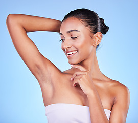 Image showing Body care, smile and woman in studio with armpit, cleaning and BO control on blue background. Smooth skin, hygiene and happy female model with laser, hair removal or underarm treatment satisfaction