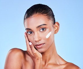 Image showing Skincare, cream and health with face of woman in studio for beauty, facial or moisturizer. Spa treatment, lotion and collagen with portrait of person on blue background for makeup, glow or sunscreen