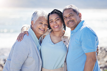 Image showing Beach, portrait and woman with her senior parents hugging and bonding on vacation together. Happy, smile and female person embracing her elderly mother and father by ocean on holiday or weekend trip.