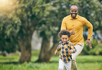Image showing Happy father, running and child at a park with freedom to playing in nature together on holiday. Love, energy or excited kid in a forest with an African father bonding with fun active games and smile