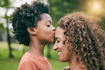 Image showing Boy, kiss mother and forehead in park, smile or profile for love, care or bonding to relax in sunshine. African mom, child and happy in garden, backyard and countryside for smile, summer and holiday