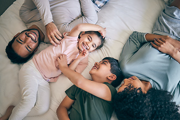 Image showing Happy family, bed and playing in bonding, weekend or day off in relax together above at home. Top view of father, mother and children smile in joy or laughing for fun parents or morning in bedroom