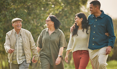 Image showing Love, walking and happy with big family in park for bonding, support and summer. Vacation, happiness and holiday with people relax in grass field in nature for peace, generations or care together