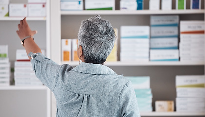 Image showing Patient, pharmacy and pharmaceutical shelf in self medication, healthcare or boxes at the drugstore. Back view of customer reaching for medical product, healthy supplements or antibiotics at clinic