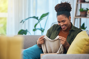 Image showing Unboxing, clothes and happy woman on sofa in home, living room and excited for online shopping, package or product. African, fashion and person smile on couch with ecommerce clothing in house