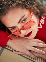 Image showing Face, fashion and sunglasses with a woman hipster relaxing closeup with trendy style for thinking. Summer, idea and outdoors with a young female person in eyewear looking bored while waiting alone