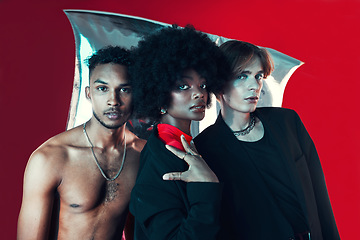 Image showing Queer, diversity and portrait of people in fashion with creative black woman, gay man and model on red background in studio. Lgbt, friends and beauty for edgy, aesthetic or unique makeup and clothes