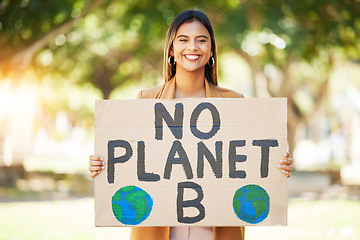 Image showing Woman, poster and climate change sign at park for earth, environment and green or eco friendly protest. Young person in portrait and nature, planet or globe support for sustainable world and action