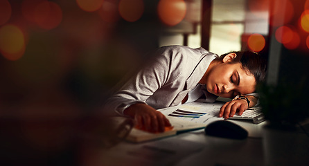 Image showing Business woman, sleep and desk in night, tired and bokeh with burnout, stress and deadline in modern office. Accountant, audit and fatigue at desk for proposal, project or rest in dark workplace