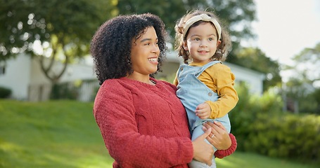 Image showing Family, kids and a mother with her adopted daughter in the garden of their foster home together. Love, smile and children with a stepmother holding her female child outdoor in the home backyard