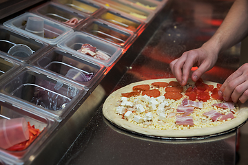 Image showing making pizza at kitchen of pizzeria