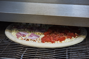 Image showing Preparing pizza in oven