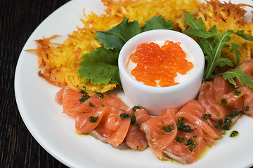 Image showing potato pancakes salmon fish and red caviar