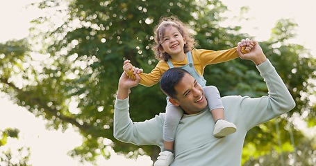 Image showing Happy, piggyback and father with girl in nature, bonding and having fun. Smile, dad and carrying child on shoulders, play and enjoying quality family time together outdoor in park with love and care.