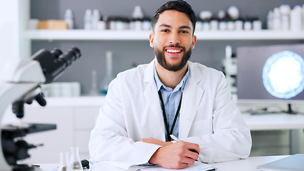 Image showing Doctor, medical researcher or surgeon, planning, taking notes and filling in forms alone at work. Portrait of one happy, smiling and cheerful scientist working at a lab, science facility or clinic
