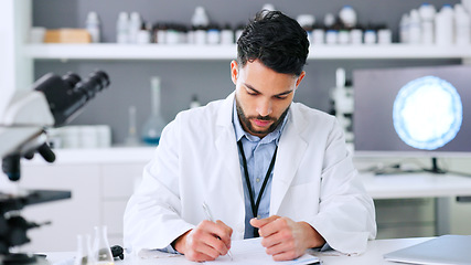 Image showing Doctor, medical researcher or surgeon, planning, taking notes and filling in forms alone at work. Scientist working at a lab, science facility or clinic