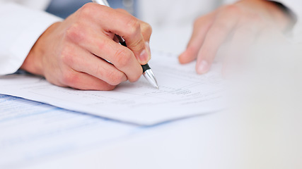 Image showing Doctor writing a prescription on paper for a patient at the hospital. Closeup of the hands of a healthcare professional drafting a medical letter or form. A GP filing a document in an office