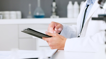 Image showing Laboratory scientist typing on a digital tablet and examining a dna test reaction to monkeypox virus during medical research. Biochemical engineer searching for a breakthrough cure on technology