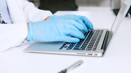 Image showing Hands of a scientist in surgical gloves, typing on a laptop in a medical lab. Closeup of a healthcare professional studying, making discovery and innovative breakthrough through DNA and RNA research