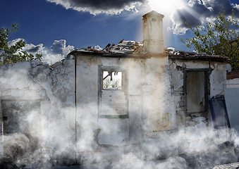 Image showing Disaster, damage and accident with house and smoke from danger, chaos fire and devastation. War, crisis and abandoned with broken building structure for grunge, construction and military attack