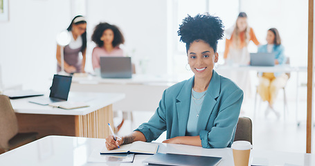 Image showing Portrait of happy woman, creative agency and writing in notebook for admin at design agency. Female designer at modern office desk, manager at startup with happiness and coworking space with notes.