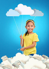 Image showing Creative, portrait and girl child with paper clouds in studio for art, fun or project with mockup on blue background. Kindergarten, poster and face of kid with banner for learning, weather or message