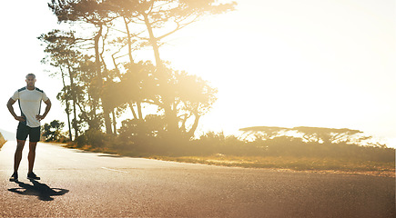 Image showing Runner, street and man with fitness, sunshine and start race with health, wellness and workout outdoor. Banner, athlete and runner in road with exercise, training for marathon race and healthy