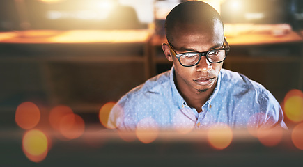 Image showing Night, flare and a business black man at work on a computer in the office for an overtime deadline. Face, technology and glasses with a young employee working on a desktop late in the evening