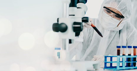 Image showing Science, blood sample and scientist in a hazmat suit doing research, experiment or study on dna. Pathology, professional and researcher working with rna vials for medical innovation in a laboratory.