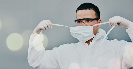Image showing PPE, face mask removal and man in safety suit of lab worker and healthcare professional in a hospital or clinic. Cleaning, bacteria protection for virus, pharmacy and wellness research with bokeh