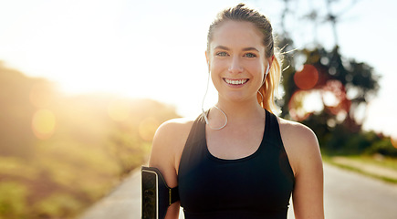 Image showing Fitness, portrait and happy woman with earphones outdoor on road at sunrise, training workout or exercise. Listening to music, smile and face of athlete in nature for wellness, healthy body or sport