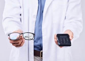 Image showing Hands, glasses and machine for pos payment, healthcare and sales for optometrist by white background. Doctor, fintech and vision expert with frame, lens and helping for wellness, health or eye care