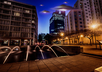 Image showing Ufo, alien mission and city at night with spaceship for science fiction and fantasy in sky with surreal glow. Spacecraft, mystery and flying saucer from outer space for discovery and invasion