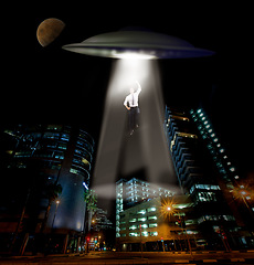 Image showing City, abduction and man with UFO, spaceship and galaxy mission with invasion, science fiction and futuristic. Extraterrestrial machine, person and kidnapping with light beam, conspiracy and mystery