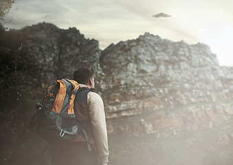 Image showing Hiking, man and ufo at mountains, spaceship or mystery adventure in countryside to travel. Trekking, alien and back of person with flying saucer, science fiction or extraterrestrial conspiracy theory