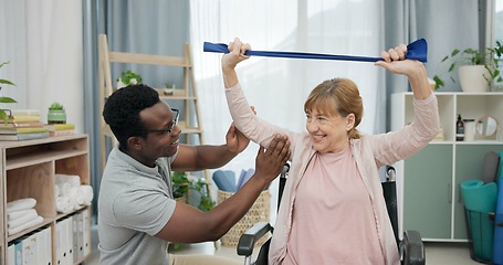 Image showing Happy senior woman with disability, physiotherapist and stretching band for muscle rehabilitation at chiropractor. Physical therapy, medical support and patient in wheelchair smile for recovery help