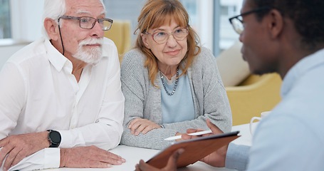 Image showing Senior couple with a male financial advisor by a table in the dining room of their modern house. Conversation, meeting and elderly man and woman planning their retirement fund with accountant at home