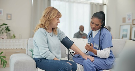 Image showing Nurse, appointment and blood pressure with senior woman at nursing home for wellness. Caregiver, service and elderly female for consultation in living room for diabetes with communication for health.